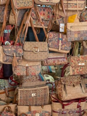 Vibrant selection of handmade patterned bags showcasing intricate designs at a local market.